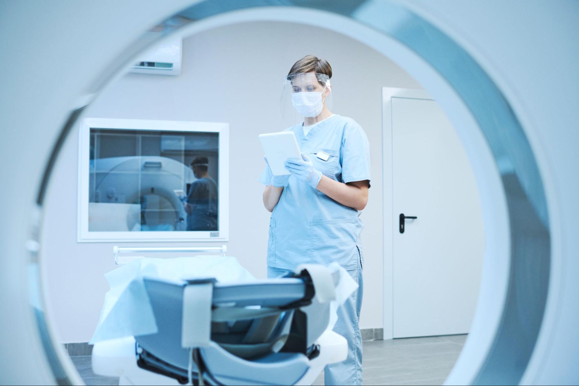 Medical professional in scrubs, mask, and gloves